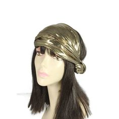 "High end stunning gold metallic spandex fabric is fashioned into a retro style knotted turban Wear in various positions...so glam Fabric is doubled then sewn together...no raw edges or exposed seams Turban head wrap will stretch to fit head circumference X 8.5\" wide at widest part FREE DOMESTIC SHIPPING on Additional Hats, Headbands & Headscarves Click here for my Headbands, Headscarves and Head Wraps https://www.etsy.com/shop/LooptheLoop?section_id=7884915 Click here for my Slouchy Hats, 20s Headpiece, Gatsby Headband, Exposed Seams, Turban Headwrap, Knotted Headband, Slouchy Hat, Knot Headband, Head Wrap, Head Circumference