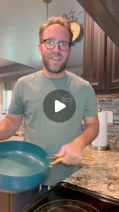 a man holding a frying pan in his hand