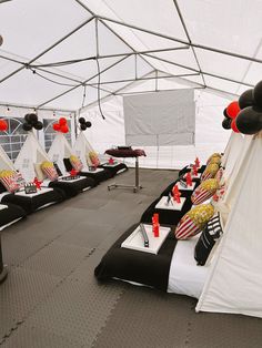 a tent set up with black and white decorations