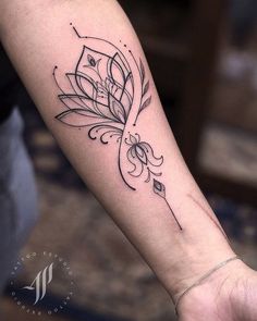 a woman's arm with a flower tattoo on it