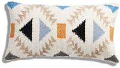 a decorative pillow with an arrow design on the front and back, in multicolored colors