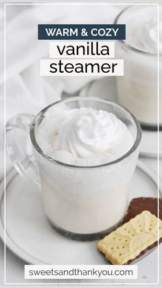 hot vanilla steamer with whipped cream in a glass mug and crackers on the side