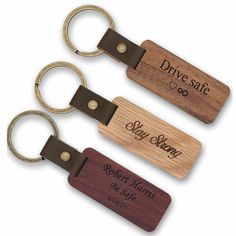 three wooden keychains with the words drive safe and stay home engraved on them