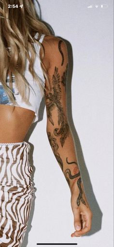 a woman with tattoos on her arm and arms