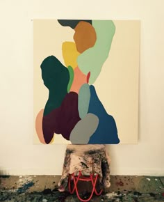 an abstract painting is displayed on the wall