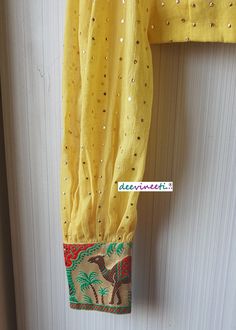 This Made to Order/Made to Measurement/Custom Made Indian Ethnic Blouse. - Fabric - Mul Cotton with Gold Mukaish Dots - Color - Yellow - Padded - Princess Cut - U Neck - Puffed Full Length Sleeves with Multicolor Border - Back Hook Closure - Border at the back Fabric Care : Dry Clean Only Disclaimer: The actual color of the product might slightly differ from the image due to photographic lighting or monitor's display Shipping: This is made to order product. Once you place the order we will provi Yellow Long Sleeve Blouse For Festivals, Yellow Cotton Anarkali Set With Self Design, Bohemian Long Sleeve Blouse For Puja, Yellow Bohemian Traditional Wear With Cutdana, Bohemian Yellow Traditional Wear With Cutdana, Bohemian Anarkali Set With Self Design For Festive Occasions, Bohemian Self Design Anarkali Set For Festivals, Festive Bohemian Anarkali Set With Self Design, Bohemian Anarkali Set With Self Design For Festivals