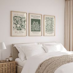 a bedroom with three framed pictures above the bed