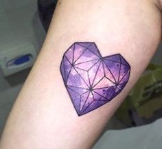 a purple heart tattoo on the arm