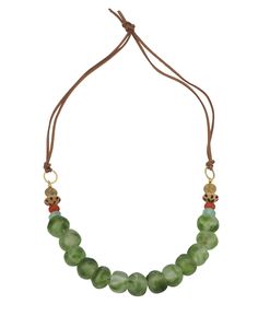 This unique necklace combines fair trade recycled glass beads, filigree brass, and natural stones to create a statement piece that reflects global craftsmanship and ethical sourcing. Design Feature: Adorned with a mix of recycled glass beads, filigree brass, and natural gemstones like fluorite and red agate. Material: Made from vegan leather, brass, and a variety of globally sourced beads Closure: Simply tie the two ends into a knot at your desired length Size: Approximately 26 inches in length, Tassels Decor, Recycled Glass Bead, Tin Gifts, Ethical Jewelry, Unique Necklace, Red Agate, Trade Beads, Glass Bead Necklace, Gemstone Bracelets