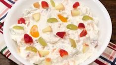 a white bowl filled with fruit salad on top of a table