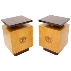 two wooden boxes with designs on them sitting next to each other