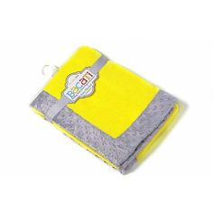 a yellow and grey blanket with a tag on it's side, sitting against a white background