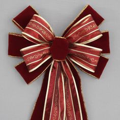 a red and gold bow on a gray background