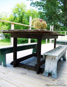 an old picnic table and bench on a deck