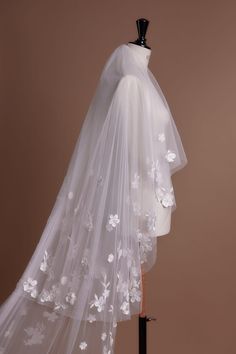 a wedding veil with white flowers on it