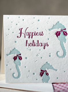 a card with seahorses on it that says happy holidays