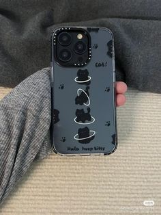 someone is holding up their phone case to show the cat's paw prints on it