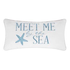 a white pillow that says meet me by the sea with a starfish on it