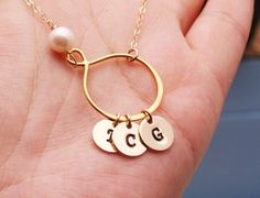 This gold pear shaped infinity necklace with initial discs consists of1. a 24k gold dipped sterling silver infinity charm connected in-line with the chain2. a birthstone bead of your choice3. one or more 14k gold filled disc charm (22ga, 3/8") stamped with an initial in your choice of font 4. a 14k gold filled chain closed with a lobster claspPackaged in a very presentable gift box (as shown)You can expect the highest stamping quality from my shop - thick gauge discs, uniformly deep impression, Gold Hypoallergenic Initial Pendant Jewelry, Hypoallergenic Gold Initial Pendant Jewelry, Adjustable Initial Pendant Jewelry For Anniversary, Gold Infinity Jewelry With Name, Personalized Gold Teardrop Jewelry, Gold Initial Pendant Jewelry For Birthday, Personalized Teardrop Jewelry For Mother's Day, Personalized Teardrop Jewelry As Gift, Personalized Teardrop Jewelry Gift