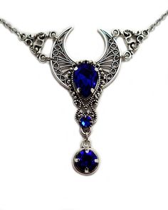 "This is a new handmade necklace. It is made with antiqued silver plated filigrees, accented with high quality DARK SAPPHIRE BLUE glass rhinestones. Decorated portion is 2 3/8\" wide and 2 1/2\" tall in the center. Necklace is adjustable 15-18\" with a lobster clasp and chain extender. If you would like a different length, please send us a message. Matching headpiece and earrings are listed in our store." Blue Festival Jewelry With Moon Charm, Blue Jewelry With Moon Charm For Festival, Festival Jewelry With Blue Moon Charm, Festival Blue Jewelry With Moon Charm, Blue Gothic Metal Necklace, Gothic Blue Metal Jewelry, Blue Gothic Metal Jewelry, Blue Metal Filigree Jewelry, Antique Silver Necklace