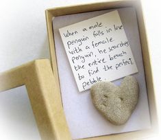 a heart shaped rock in a box with a note attached to the inside of it