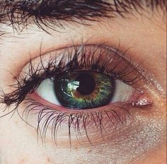 an extreme close up shot of a person's blue eye