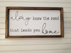 a sign hanging on the wall that says always know the road that leads you home