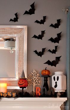 a mantle with halloween decorations and bats on it