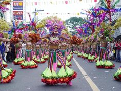 some people are walking down the street in colorful costumes