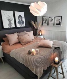 a bed with candles and pictures on the wall above it, along with other decor items