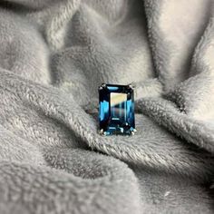 a blue ring sitting on top of a blanket