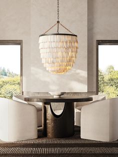 a dining room table with two chairs and a chandelier hanging from the ceiling