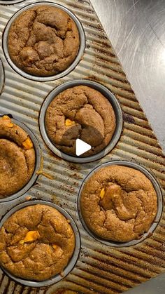 several muffins sitting on top of a metal tray next to a cupcake tin