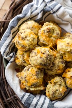 a basket filled with cheesy muffins on top of a table