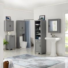 a bathroom with gray cabinets and white fixtures