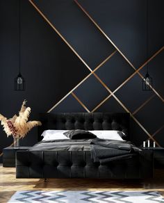 a black bedroom with gold lines on the wall and a large bed in front of it