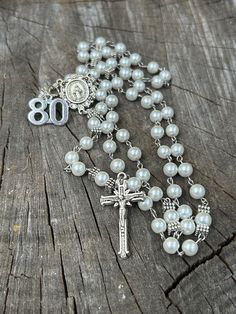 This is  a perfect gift for someone's 80th Birthday . Hand made very strong rosary. Made with glass pearl beads, beautiful silver plated hearts, Stainless steel and silver plated Findings, a traditional Rosary Centerpiece and a traditional Catholic crucifix.  All of my Rosaries are handmade by myself. I take pride in my work. I use quality and strong products. I make my Rosaries to last so you can enjoy them and pass them down to future generations!  As always, if you have any questions, please White Spiritual Rosary For Anniversary, Mother's Day Rosary With 8mm Beads, Rosary Beads Catholic, Catholic Crucifix, 80th Birthday Gifts, Rosary Catholic, Rosary Beads, Catholic Gifts, 80th Birthday