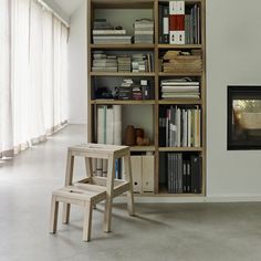 a chair and table in front of a bookshelf