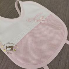 a pink bib with white polka dots on it