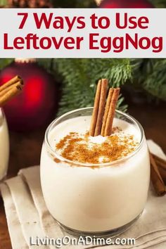 an eggnog drink in a glass with cinnamon sticks