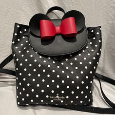 Authentic Disney X Kate Spade New York Minnie Mouse Backpack. In Exceptional Pre-Owned Condition. Used Only A Handful Of Times. - Style # K4642 - Refined Grain Leather - Trim: Smooth Leather - Metal Pinmount Logo - Two Way Spade Jacquard Lining - Interior Back Zip Pocket - Flap With Magnetic Snap Closure - Dust Bag Not Included Measurements: 9.3'' H X 9.8'' W X 5.3'' D Without Ears And Bow Handle Drop: 2.5'' Kate Spade Backpack Purse, Mickey Mouse Backpack, Kate Spade Minnie Mouse, Minnie Mouse Backpack, Disney Adult, Kate Spade Backpack, Kate Spade Disney, Vintage Kate Spade, Minnie Mouse Bow