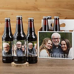 four beer bottles with an image of the same man and woman on them are sitting next to a father's day card