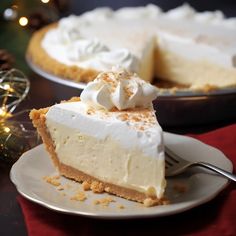 a slice of cheesecake on a plate with a fork in front of the pie