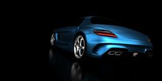 a blue sports car is shown in the dark