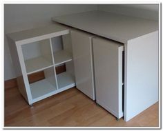 a small white cabinet sitting next to a radiator on a hard wood floor