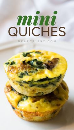 two muffins stacked on top of each other with spinach and cheese in the middle