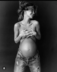 a black and white photo of a pregnant woman