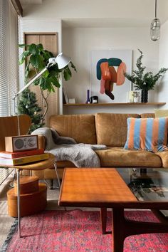 a living room filled with furniture and plants