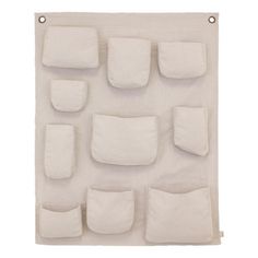 a white wall hanging with several pieces of cloth on it's sides and four pockets