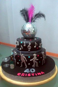 a birthday cake with disco balls and musical notes on it's top tiers